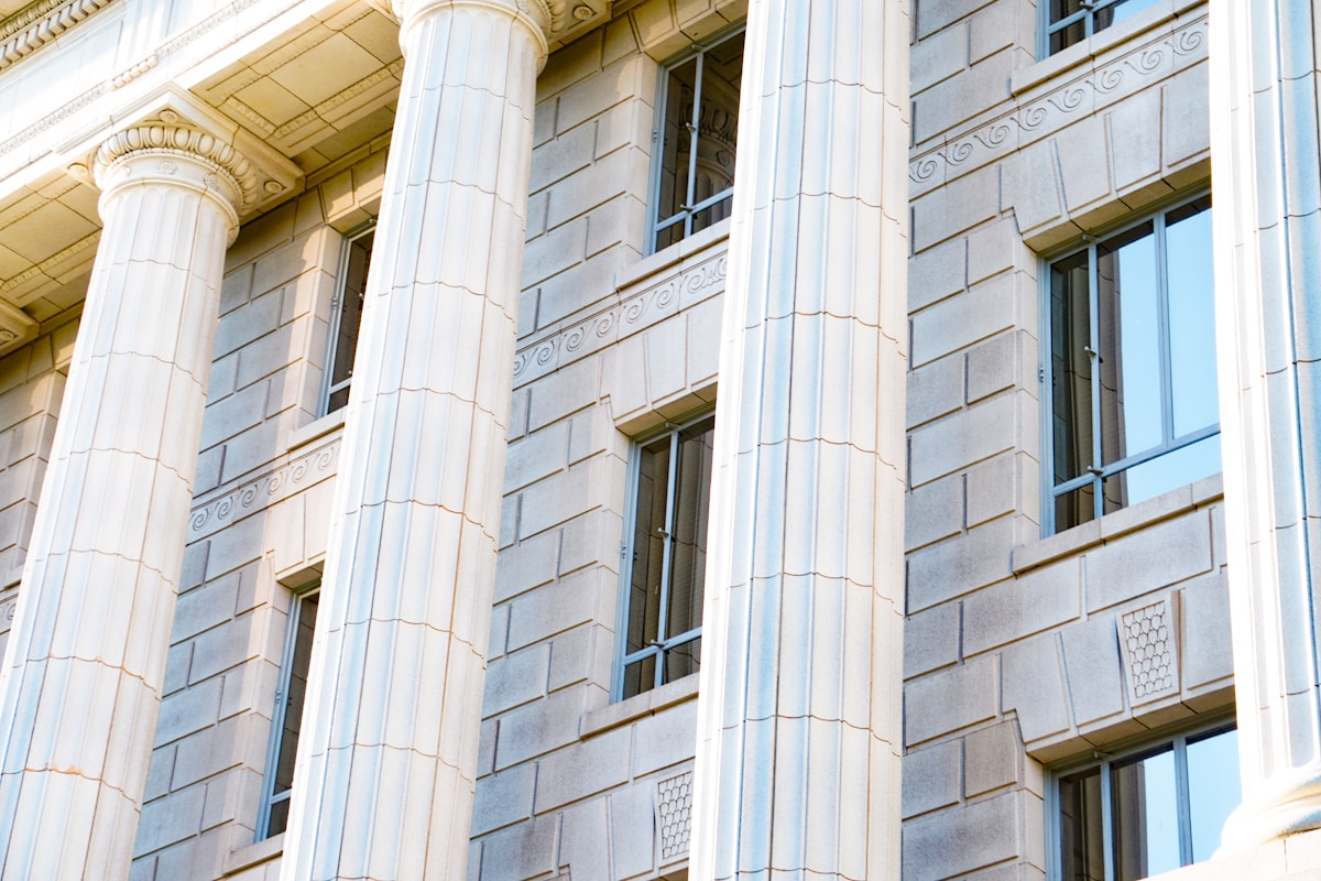 A state capitol building at dusk with warm light in the windows