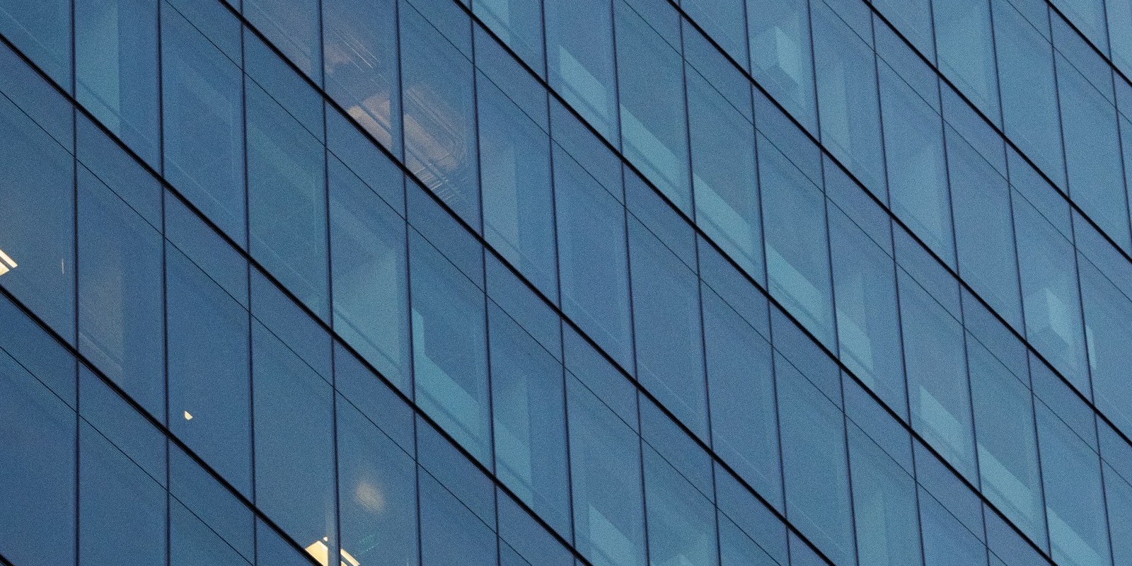 The mirrored-glass facade of a corporate office tower